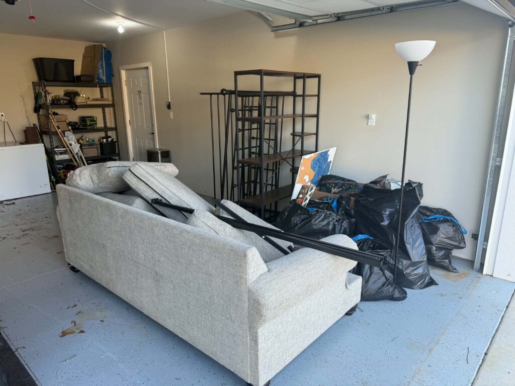 Furniture and other unwanted items in a garage before removal