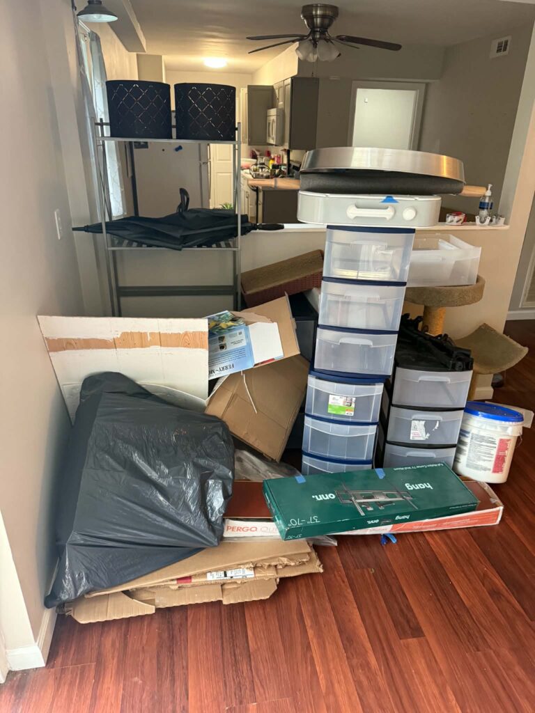 Plastic storage containers and assorted unwanted household items inside a Lenoir City home.