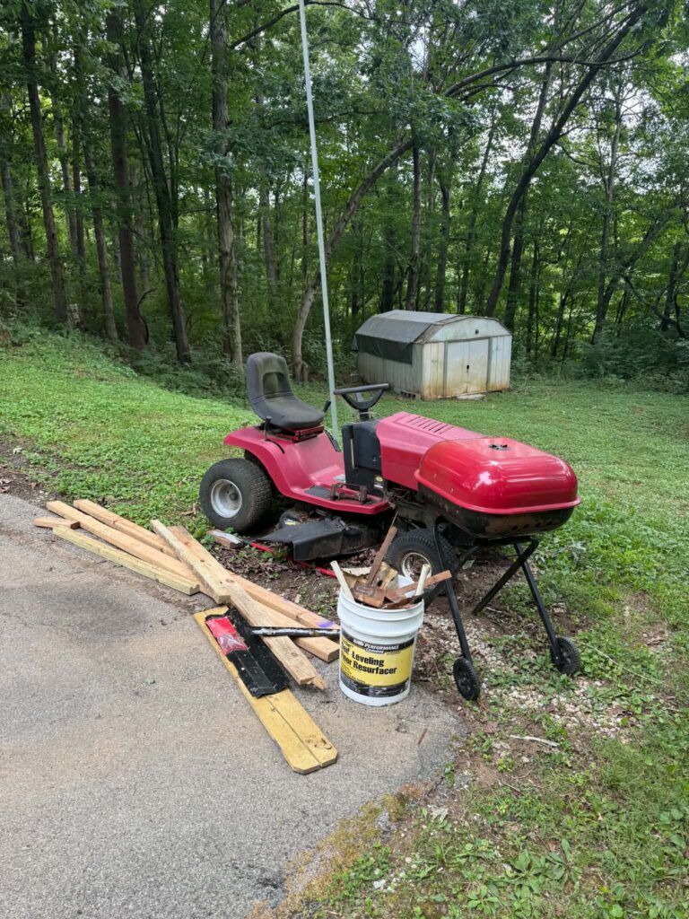 Riding mower and miscellaneous outdoor items at a Lenoir City junk-removal job.