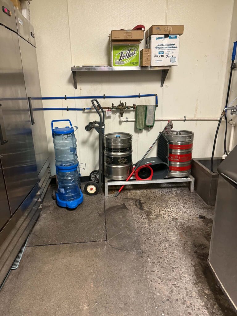 Additional view of restaurant back-room equipment, shelving and supplies
