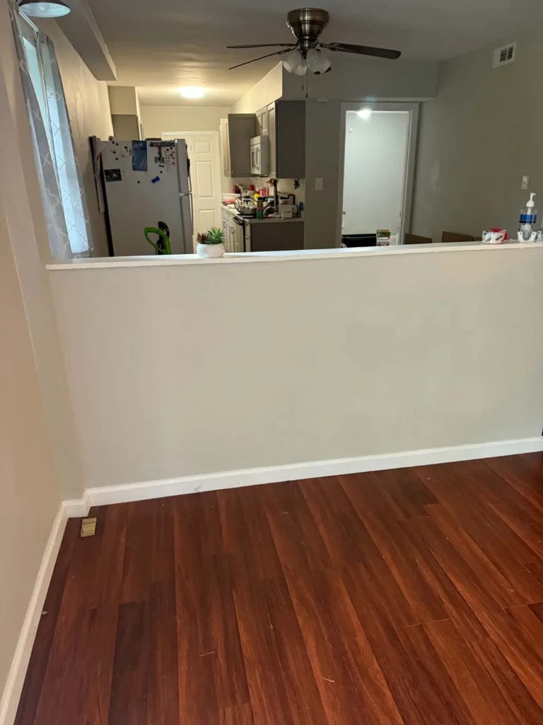 Interior living area beside the kitchen at a Lenoir City junk-removal job.